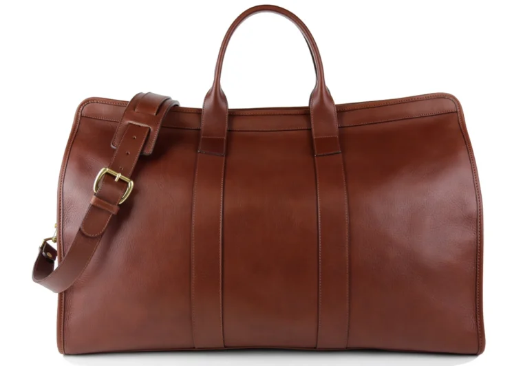 Full-grain leather Indochine duffle bag on wooden surface