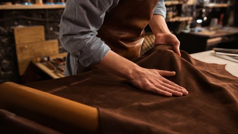 Vietnamese artisan preparing vegetable-tanned leather hides